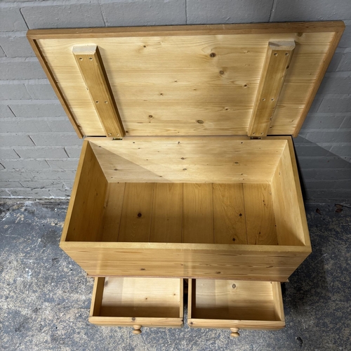 143 - A pine blanket box with lift up lid, bottom section with two drawers, on bracket feet, 83cm wide