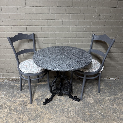 152 - A cast iron bar/kitchen table with circular granite top together with two grey painted bentwood chai... 