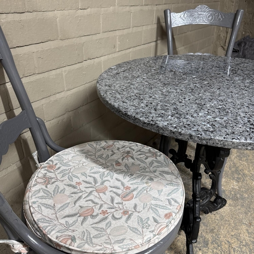 152 - A cast iron bar/kitchen table with circular granite top together with two grey painted bentwood chai... 