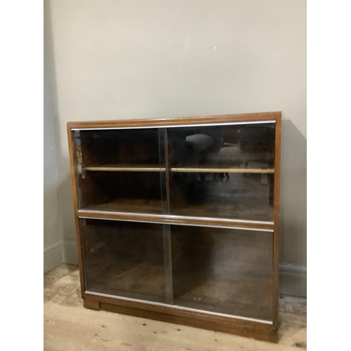 298 - A mahogany two section Minty bookcase with glazed sliding doors, plinth base