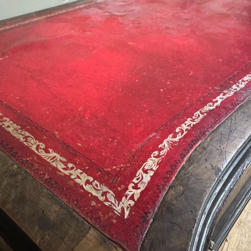 309 - A 1950s serpentine fronted walnut writing desk, two drawers , incised red leather writing surface, c... 