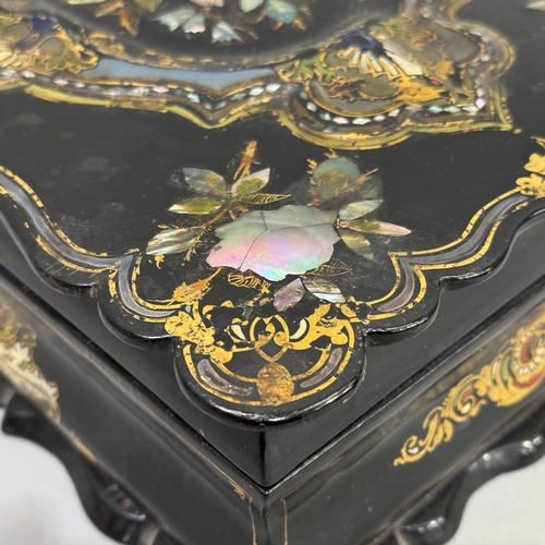 41 - A Victorian black paper-mâché lady's box inlaid with mother-of-pearl and gilt decoration, the interi... 