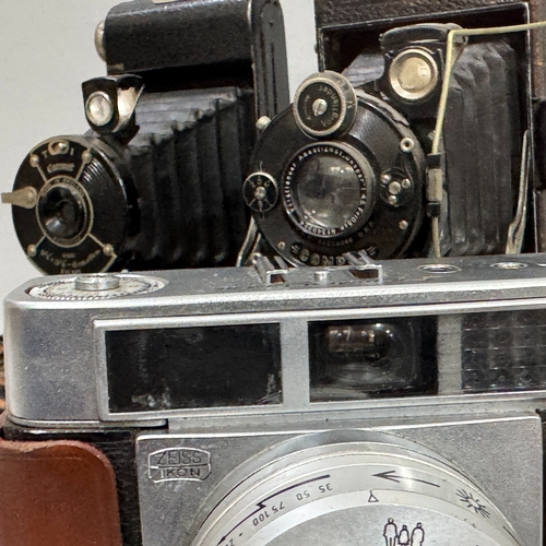 63 - A Zeiss Ikon Prontormat SLR camera in leather case together with a Coronet folding camera and a Voig... 