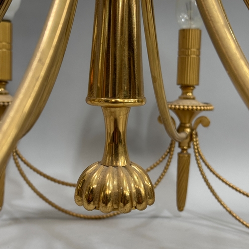 72 - A gilt metal eight light electrolier with beaded detail  and swags