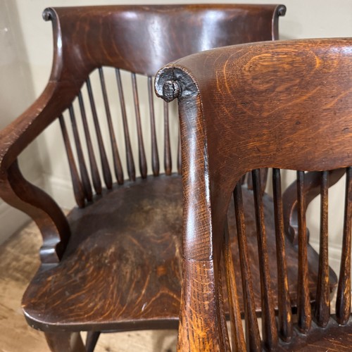 322 - A pair of early 20th century oak office shape of tub shape with slender spindle backs, on cabriole l... 