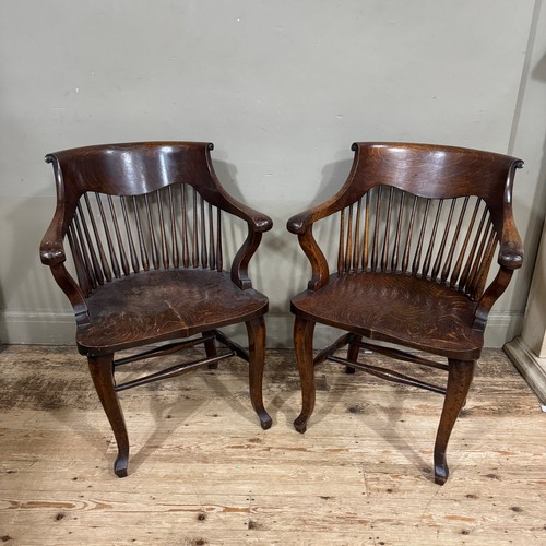 322 - A pair of early 20th century oak office shape of tub shape with slender spindle backs, on cabriole l... 