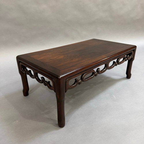 326 - An oriental fruitwood coffee table on turned legs with carved skirt, 76cm wide, 41cm deep, 27cm high