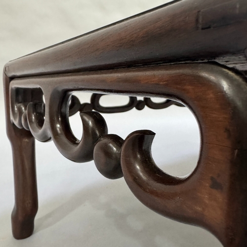 326 - An oriental fruitwood coffee table on turned legs with carved skirt, 76cm wide, 41cm deep, 27cm high