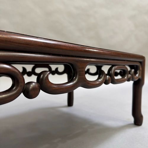 326 - An oriental fruitwood coffee table on turned legs with carved skirt, 76cm wide, 41cm deep, 27cm high