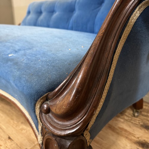 348 - A Victorian mahogany chaise longue buttoned blue velvet upholstery, swept upright and knopped legs w... 