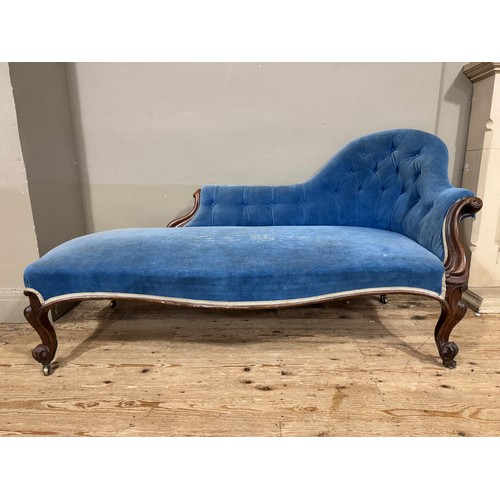 348 - A Victorian mahogany chaise longue buttoned blue velvet upholstery, swept upright and knopped legs w... 