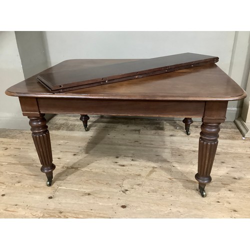 350 - A Victorian mahogany extending dining table with two leaves, rounded corners and on reeded and turne... 