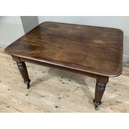 350 - A Victorian mahogany extending dining table with two leaves, rounded corners and on reeded and turne... 