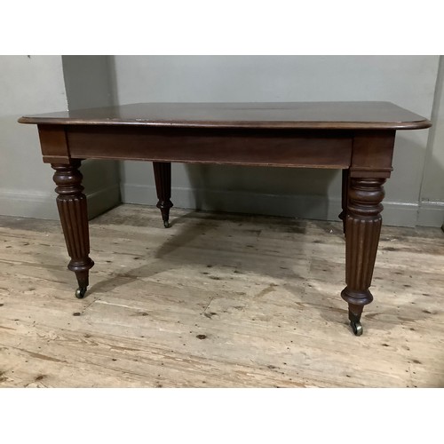 350 - A Victorian mahogany extending dining table with two leaves, rounded corners and on reeded and turne... 