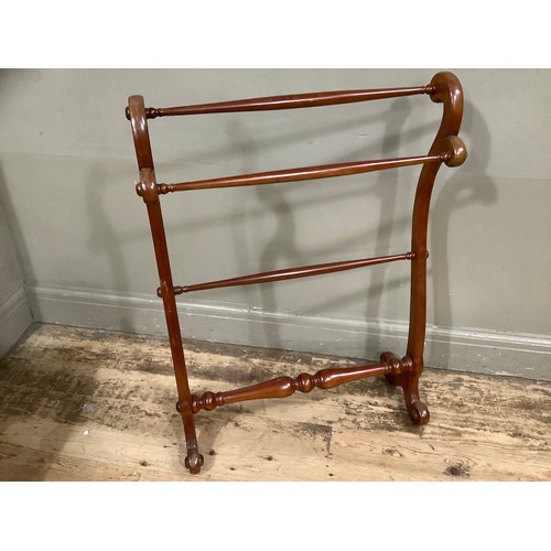 357 - A Victorian mahogany towel rail on serpentine uprights, three cross bars and bifurcated legs