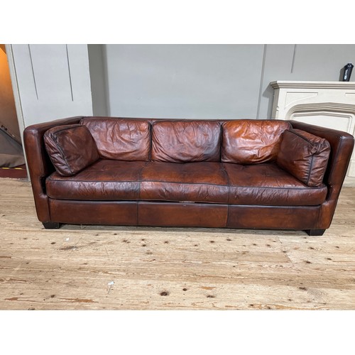 374 - A dark tan/brown leather three seater sofa with loose back and side cushions, 230cm x 98cm