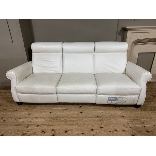 375 - A Itala cream leather three seater sofa and armchair, reclining, 205cm