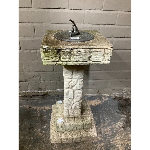 146 - A reproduction cast concrete sundial, 63cm high