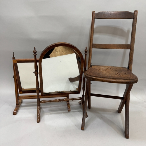 337 - An early 20th century child's folding chair together with a mahogany toilet mirror of arched outline... 