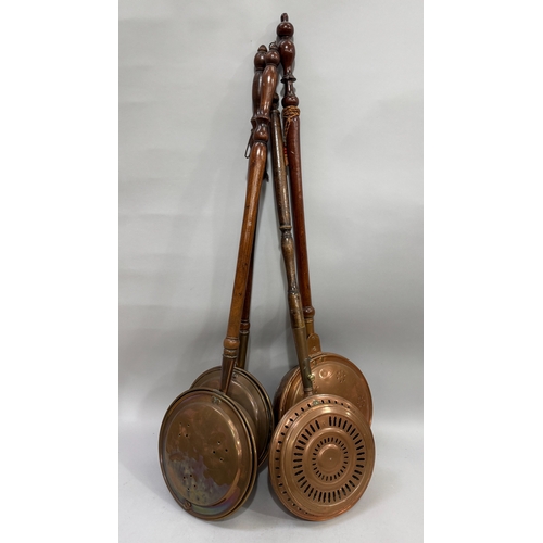 340 - Four 19th century copper bed warmers each on a turned wooden handle