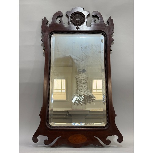 346 - A mahogany Chippendale style wall mirror with fret cut frame and carved shell motif, 92cm x 50cm