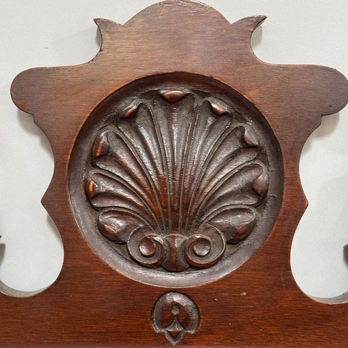 346 - A mahogany Chippendale style wall mirror with fret cut frame and carved shell motif, 92cm x 50cm