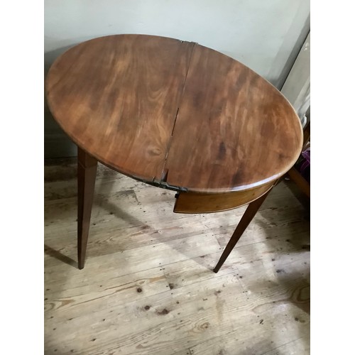 351 - An early 19th century fold over demi-lune tea table on square tapered legs