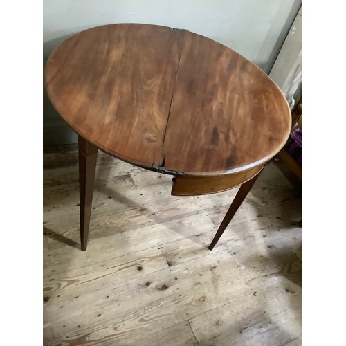 351 - An early 19th century fold over demi-lune tea table on square tapered legs