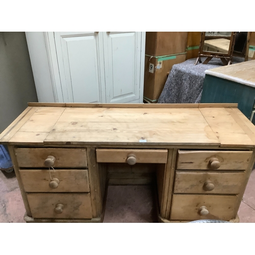 138 - A Victorian pine pedestal desk, kneehole with single drawer flanked by pedestals of three graduated ... 