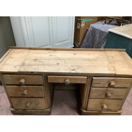 138 - A Victorian pine pedestal desk, kneehole with single drawer flanked by pedestals of three graduated ... 