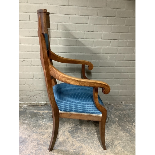 148 - A large high backed fruitwood armchair on splayed legs, with blue upholstered seat and back