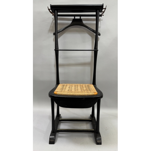 320 - An gentleman's ebonised valet having a hinged coat rail, the frame as a rush seated chair, with draw... 