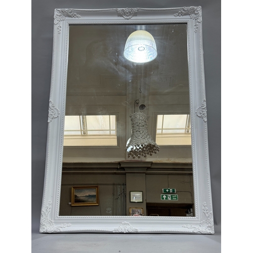 323 - A large white painted rectangular wall mirror, 85cm x 128cm