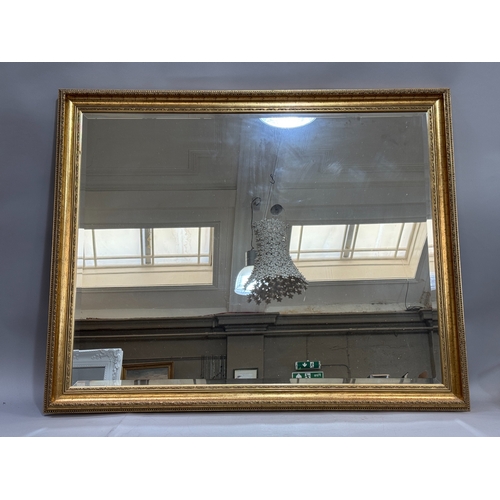 334 - A large gilt framed wall mirror of rectangular outline, 132cm x 107cm