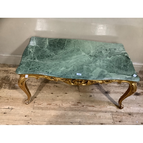 355 - A marble and gilt coffee table, serpentine outline and on leaf carved cabriole legs and with carved ... 