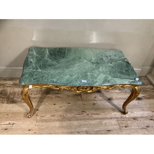 355 - A marble and gilt coffee table, serpentine outline and on leaf carved cabriole legs and with carved ... 