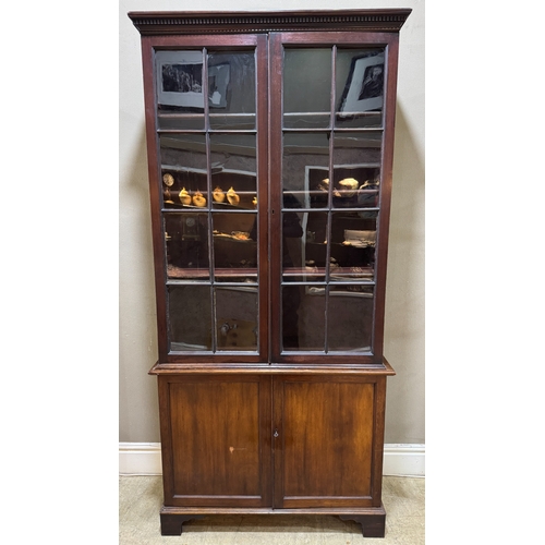 363 - A mahogany bookcase having two glazed doors above two door cupboard below, associated top and bottom