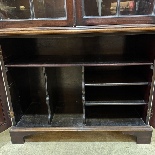 363 - A mahogany bookcase having two glazed doors above two door cupboard below, associated top and bottom