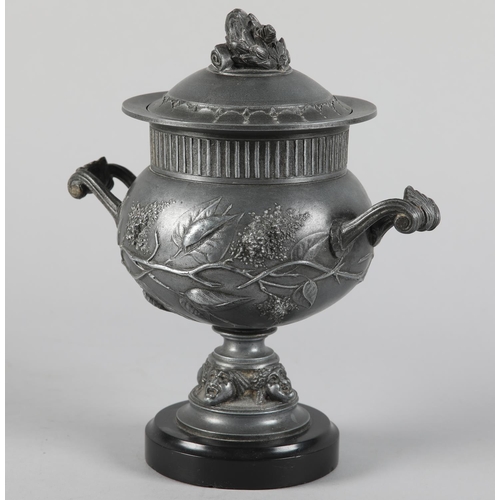 64 - A LATE 19TH CENTURY PEWTER TWO-HANDLED URN AND DOMED COVER with laurel wreath finial, reeded rim abo... 