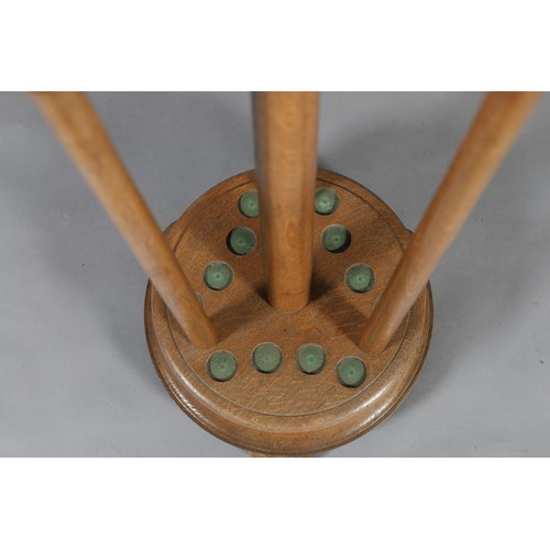 21 - AN EARLY 20TH CENTURY OAK CUE RACK with ball finial, with gilt metal, stained and natural bone clips... 