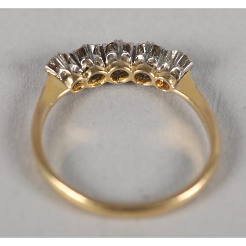 366 - A five stone diamond ring c1960, the graduated brilliant cut stones claw set in line, in yellow and ... 