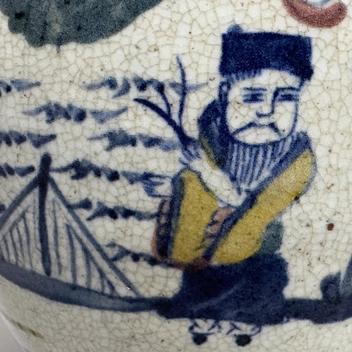 21 - A stoneware vase painted in the chinoiserie manner in underglaze blue, yellow and enamel on a crackl... 