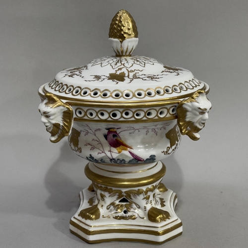 23 - A continental pot pourri vase, the semi domed cover with bud finial, the rim with four applied face ... 