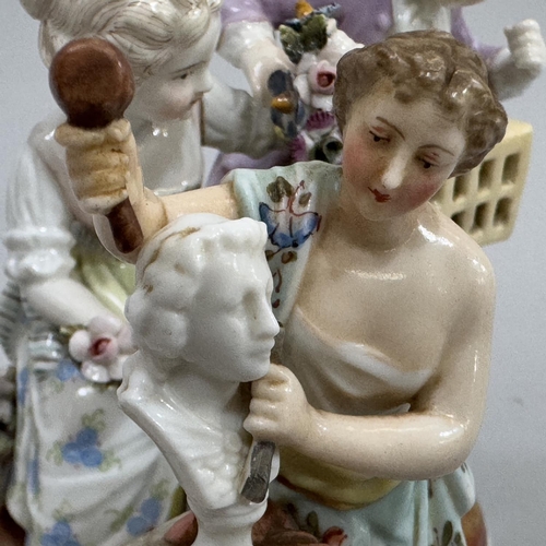 46 - A German figure group of girl and boy with garland of flowers and birdcage, underglaze blue