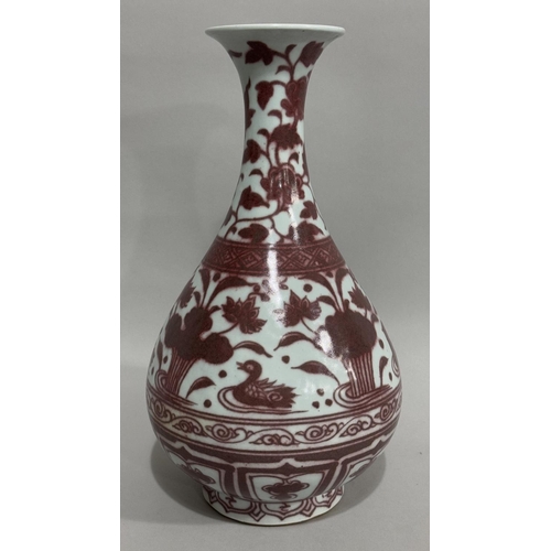 7 - A modern Chinese vase of tear shape with everted rim in wine with a continuous scene of water fowl a... 