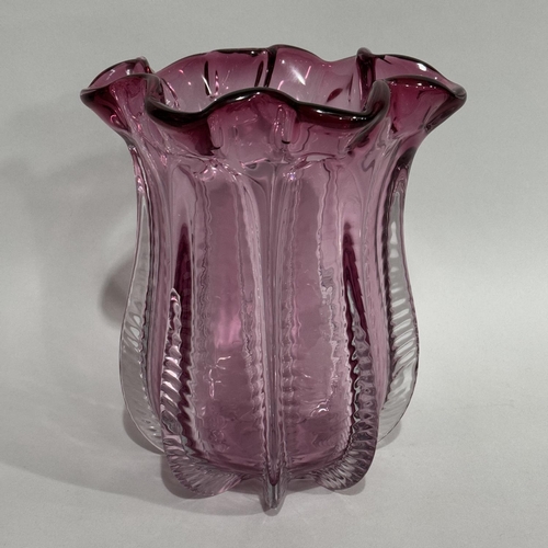 8 - An amethyst glass vase of flower bud form with folded rim, 27cm high