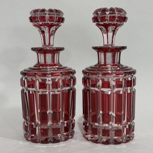 9 - A pair of ruby flash cut glass decanters with mushroom stoppers, 21.5cm