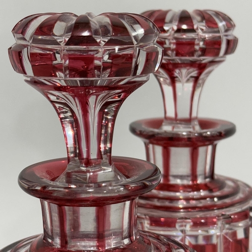 9 - A pair of ruby flash cut glass decanters with mushroom stoppers, 21.5cm