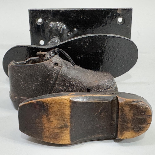 56 - A pair of infant's leather and wood clogs together with a cobbler's child sized last