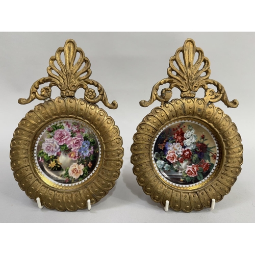 57 - A pair of china dishes printed with  floral still lives mounted in gilt metal, circular scalloped fr... 